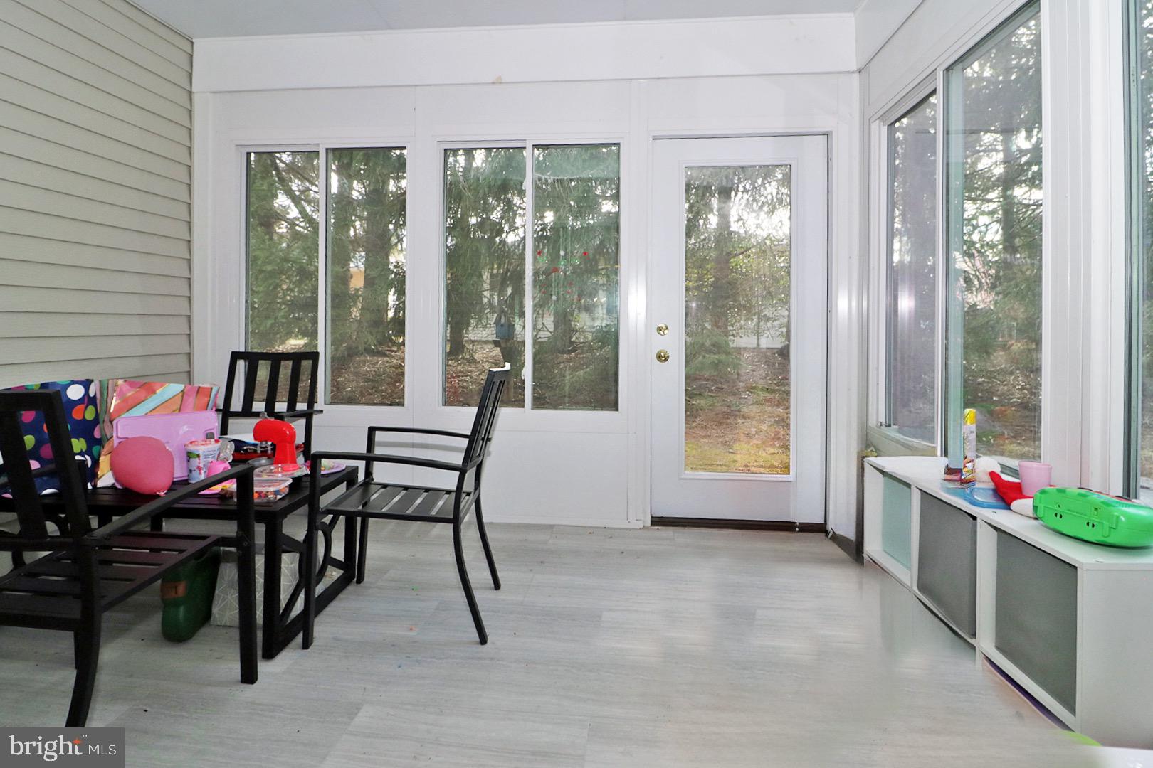 23 Abbey Road Brick, NJ 08723 - Photo 30 of 37 a living room with furniture and a floor to ceiling window