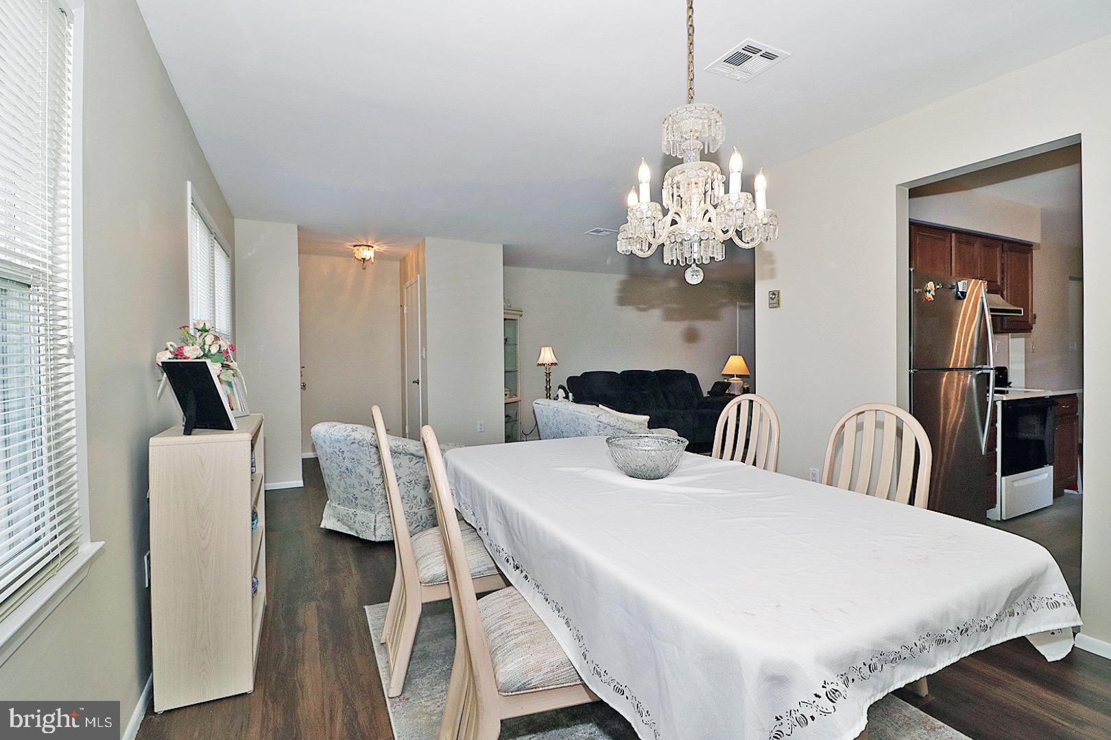 23 Abbey Road Brick, NJ 08723 - Photo 7 of 37 a view of a dining room with furniture and wooden floor