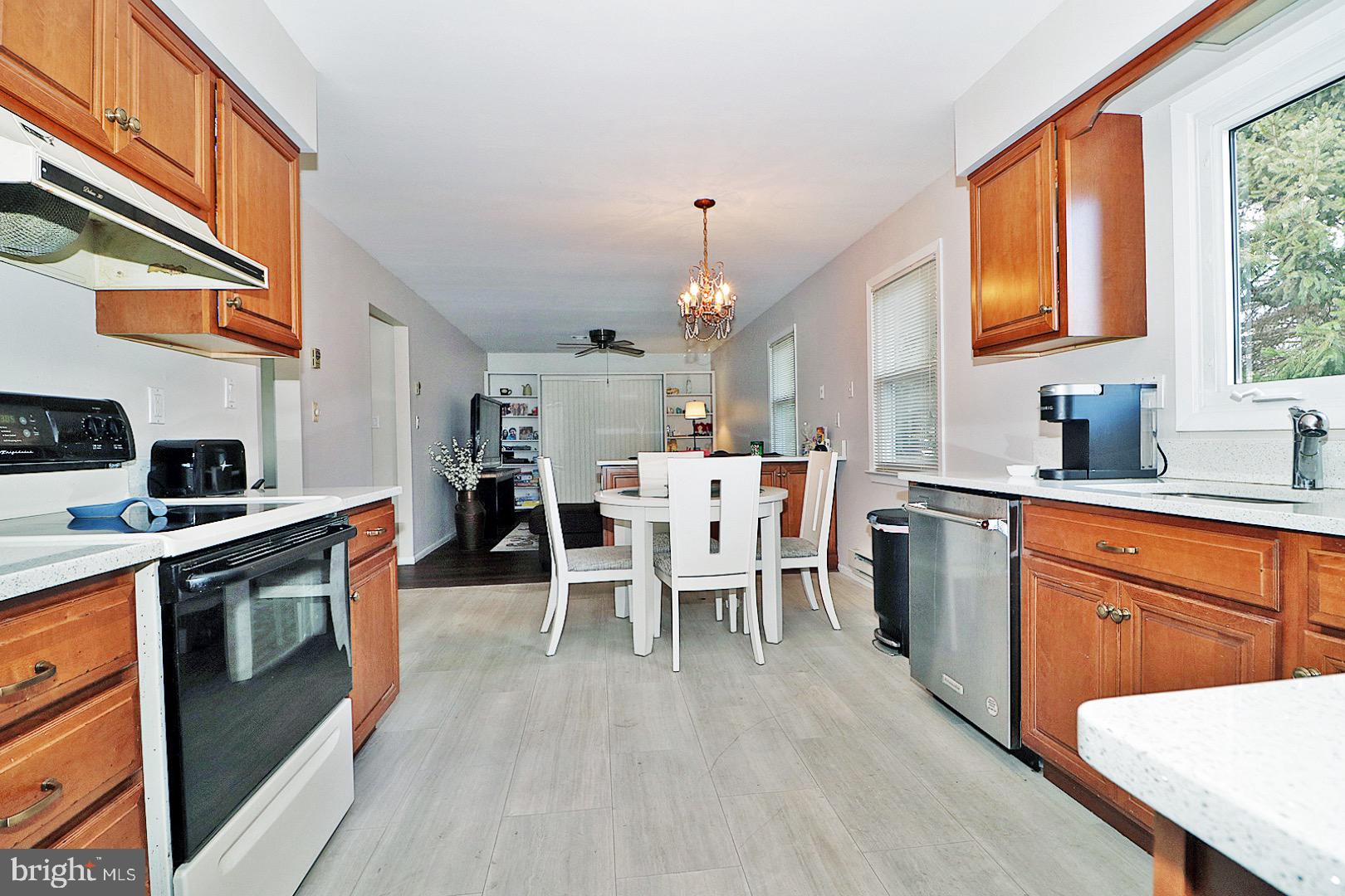 23 Abbey Road Brick, NJ 08723 - Photo 8 of 37 a large kitchen with a table and chairs