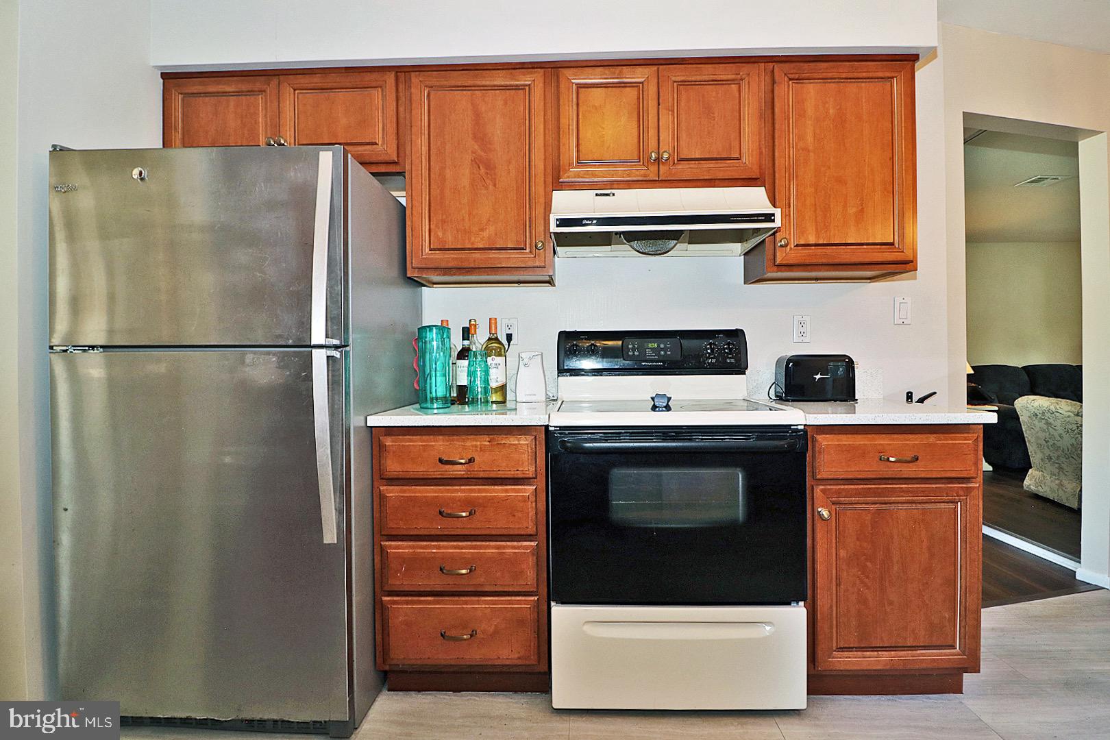 23 Abbey Road Brick, NJ 08723 - Photo 9 of 37 a white refrigerator freezer and a stove sitting inside of a kitchen