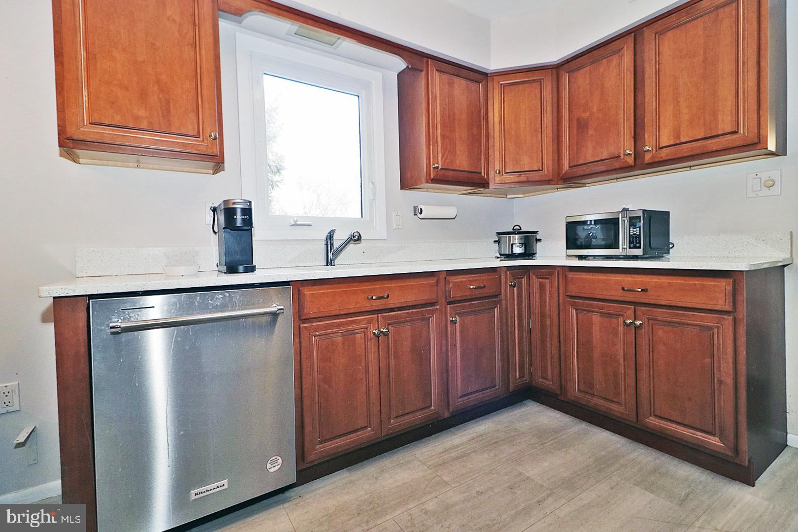 23 Abbey Road Brick, NJ 08723 - Photo 10 of 37 a kitchen with a sink dishwasher window and cabinets