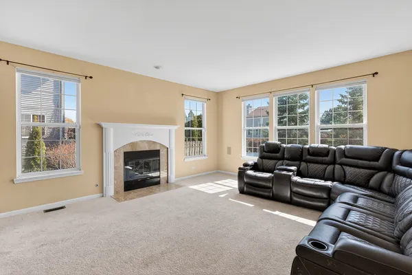 a living room with furniture window and a fireplace