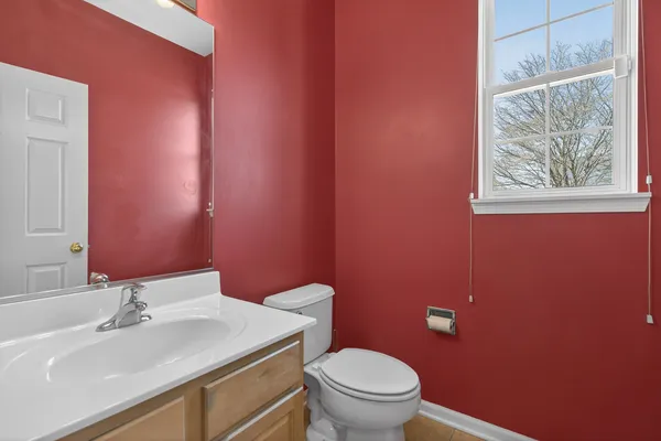 a bathroom with a sink a toilet and mirror