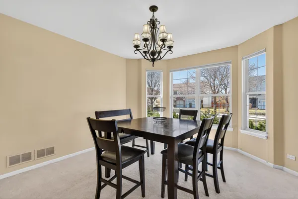 a view of a dining room with furniture window and outside view