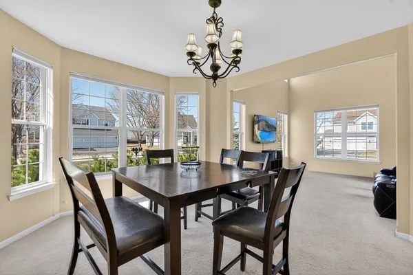 a view of a dining room with furniture wooden floor and chandelier