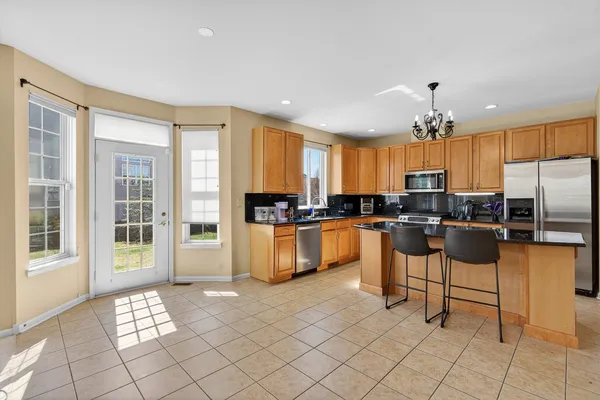a kitchen with a refrigerator and cabinets