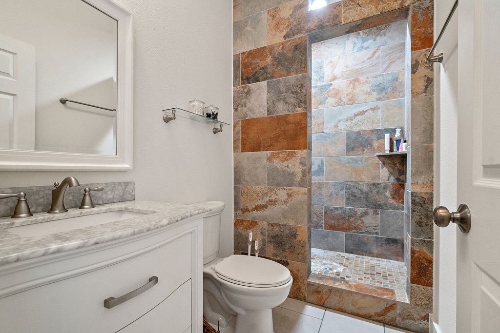 784 Ranch Road 2721 Johnson City, TX 78636 - Photo 17 of 20 a bathroom with a granite countertop sink toilet and shower