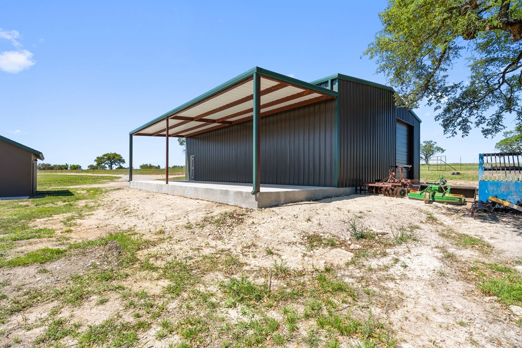 784 Ranch Road 2721 Johnson City, TX 78636 - Photo 20 of 20 a backyard of a house with a yard and garage