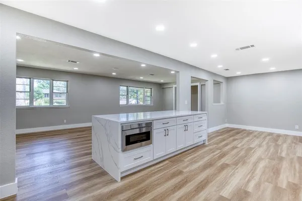 a kitchen with stainless steel appliances granite countertop a stove and a refrigerator