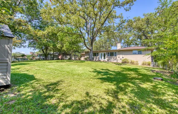 a view of house with garden space and trees