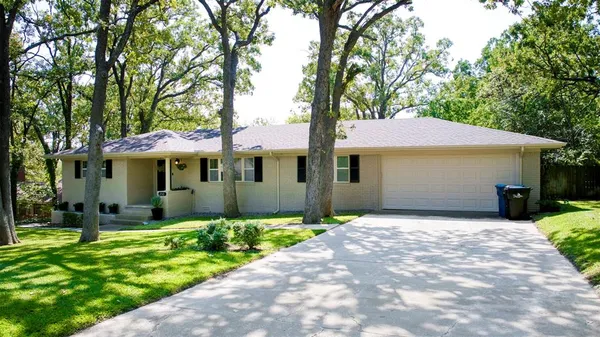 a front view of a house with a garden and yard