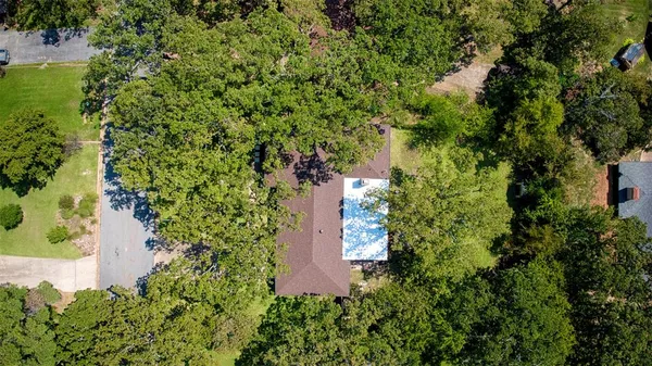 an aerial view of a house with a yard