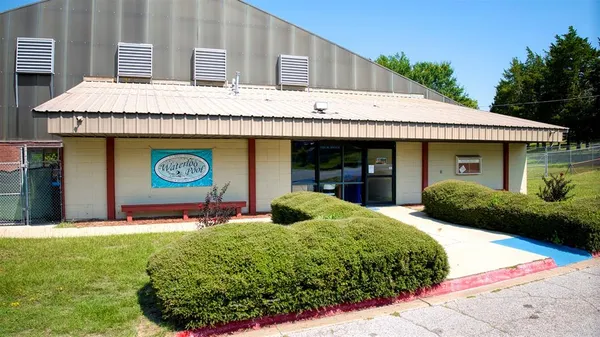 a front view of a building with garden