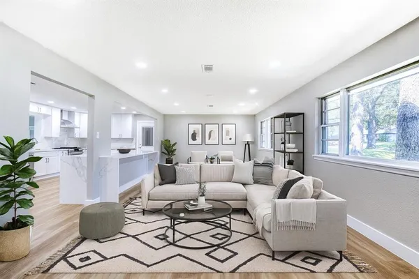 a living room with furniture and a large window