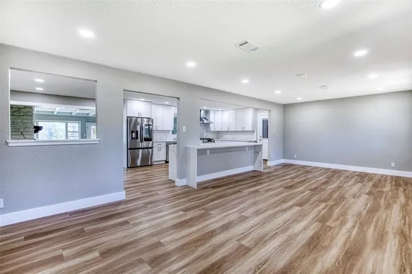 a view of kitchen with wooden floor and window