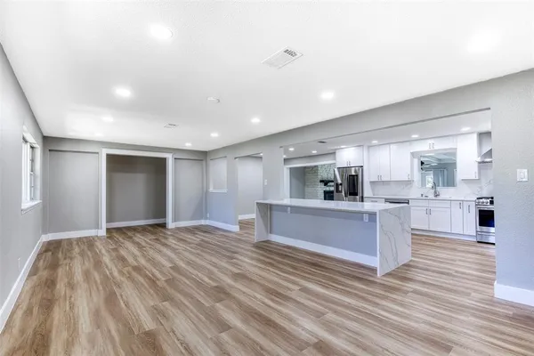 a view of kitchen with sink and wooden floor