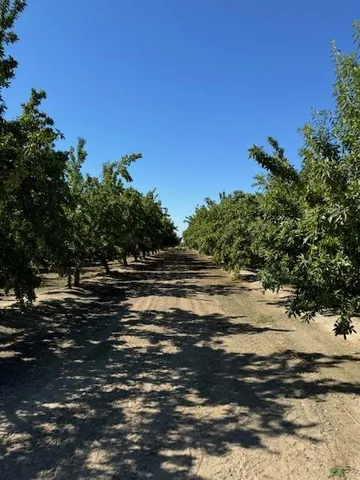 a bed sitting in a bedroom next to a window with a dresser