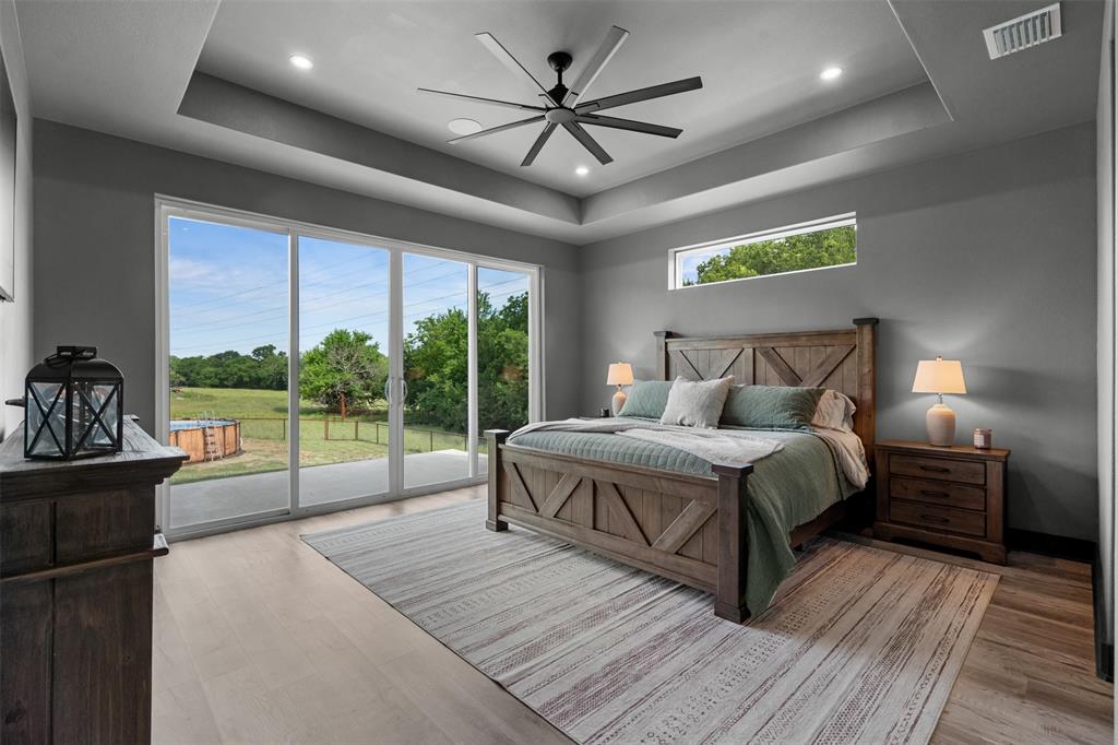 7899 County Road 623 Blue Ridge, TX 75424 - Photo 11 of 39 a bedroom with a large bed and a balcony