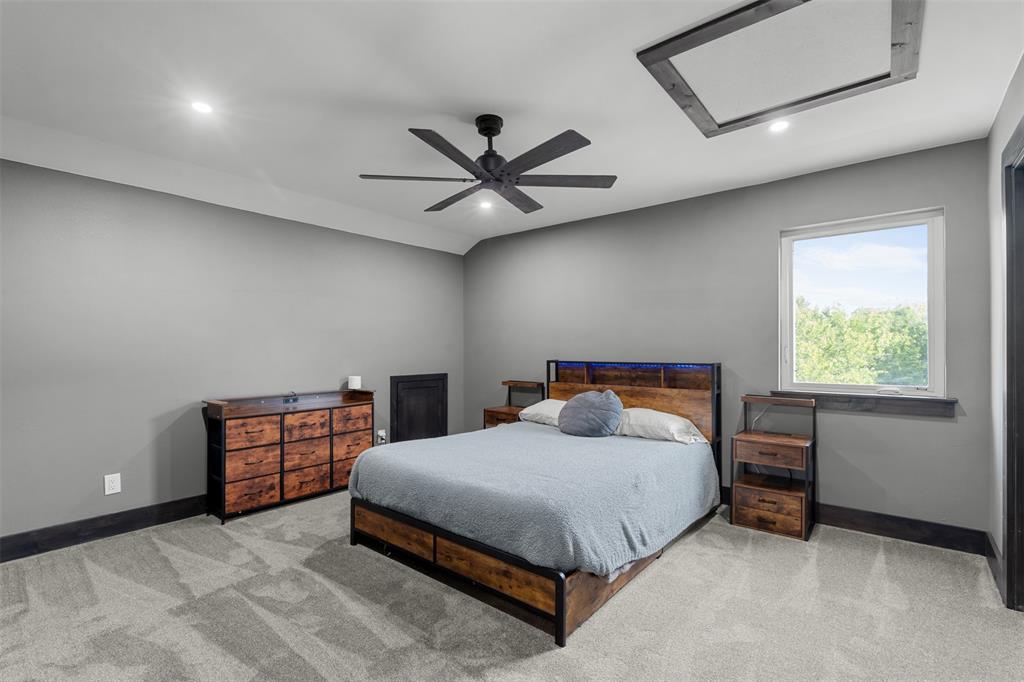 7899 County Road 623 Blue Ridge, TX 75424 - Photo 17 of 39 a bedroom with a bed and a ceiling fan