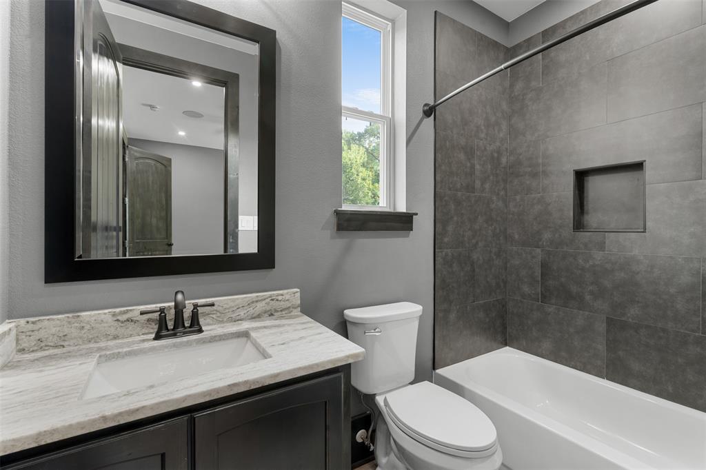 7899 County Road 623 Blue Ridge, TX 75424 - Photo 21 of 39 a bathroom with a sink a toilet and shower