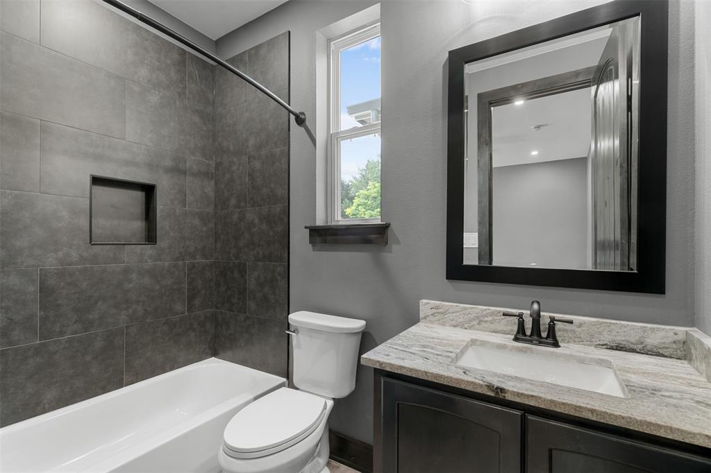 7899 County Road 623 Blue Ridge, TX 75424 - Photo 22 of 39 a bathroom with a granite countertop sink toilet a large mirror and shower
