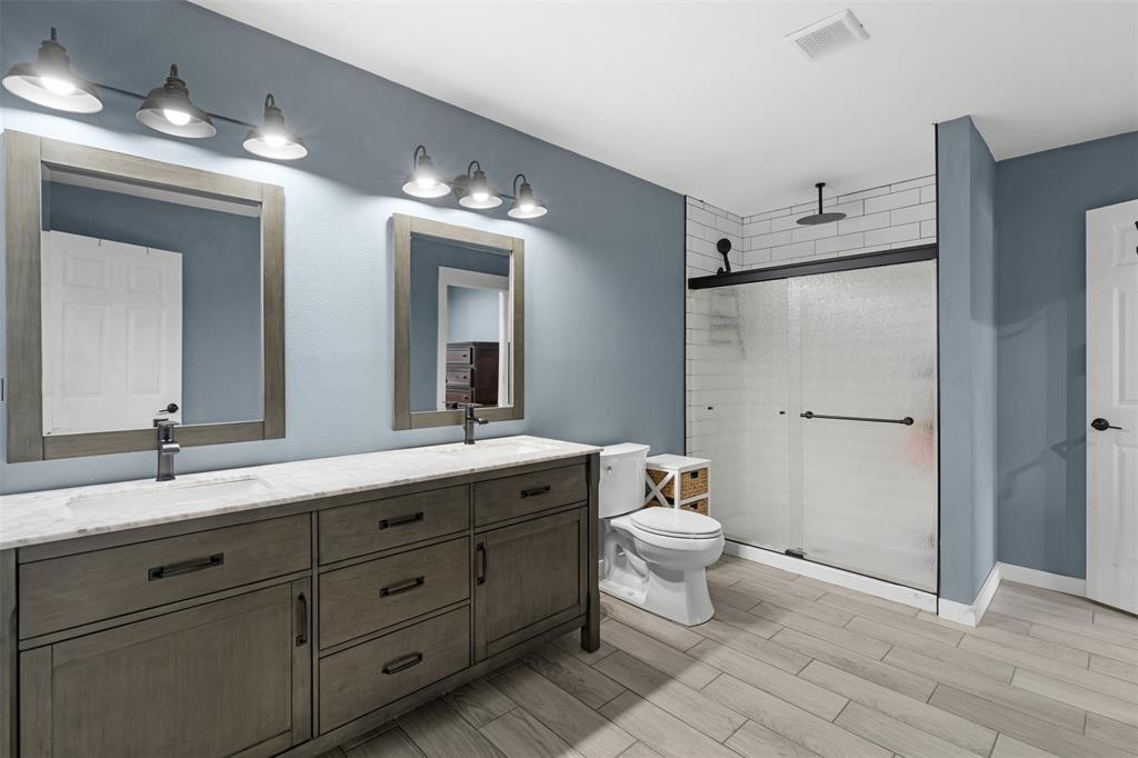 7899 County Road 623 Blue Ridge, TX 75424 - Photo 31 of 39 a spacious bathroom with a double vanity sink mirror and toilet