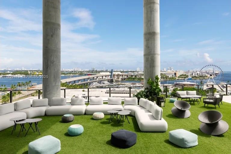 398 Northeast 5th Street, Unit 4409 Miami, FL 33132 - Photo 18 of 30 a living room with patio chairs and a potted plant