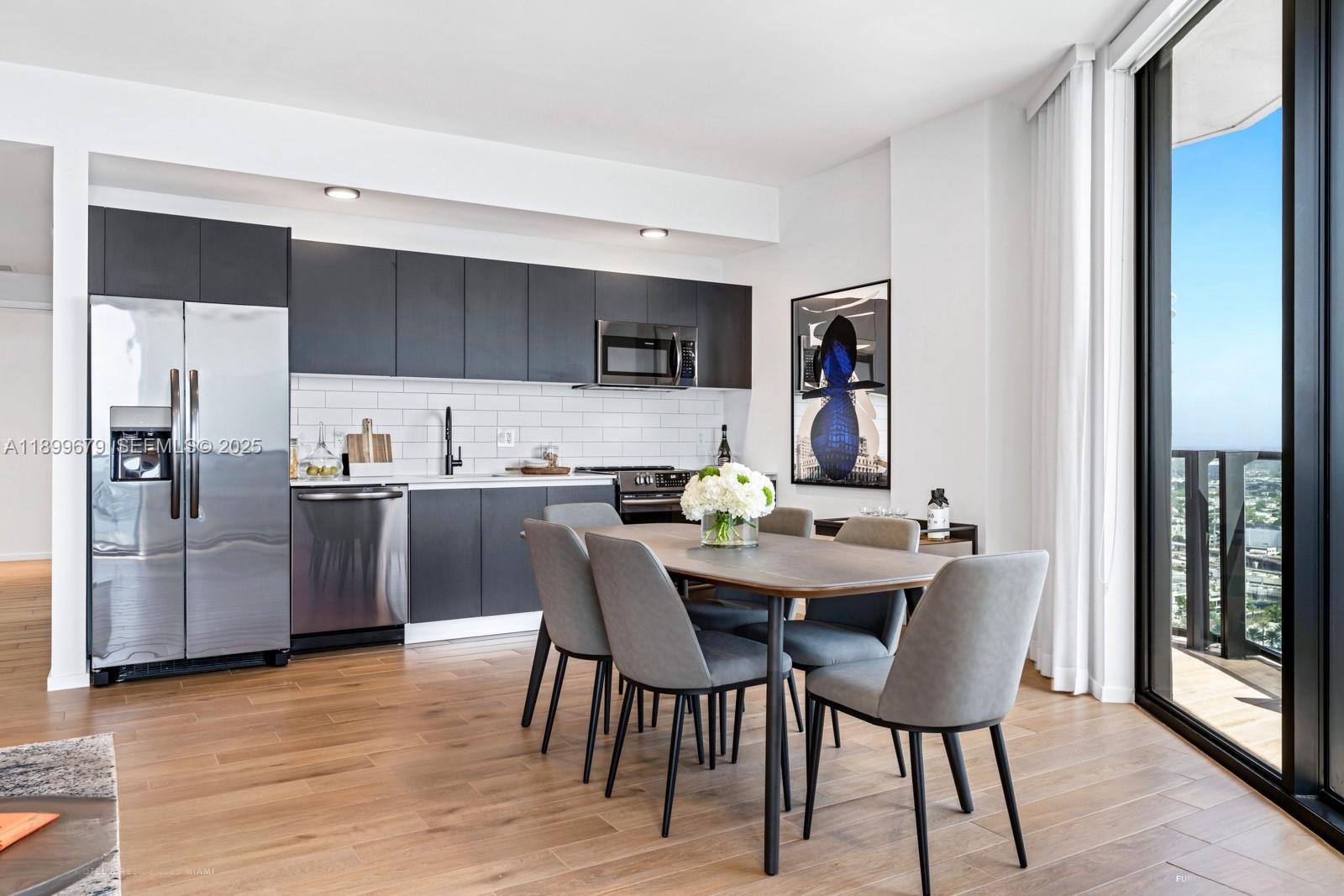 398 Northeast 5th Street, Unit 4409 Miami, FL 33132 - Photo 7 of 30 a view of a dining room with furniture and wooden floor