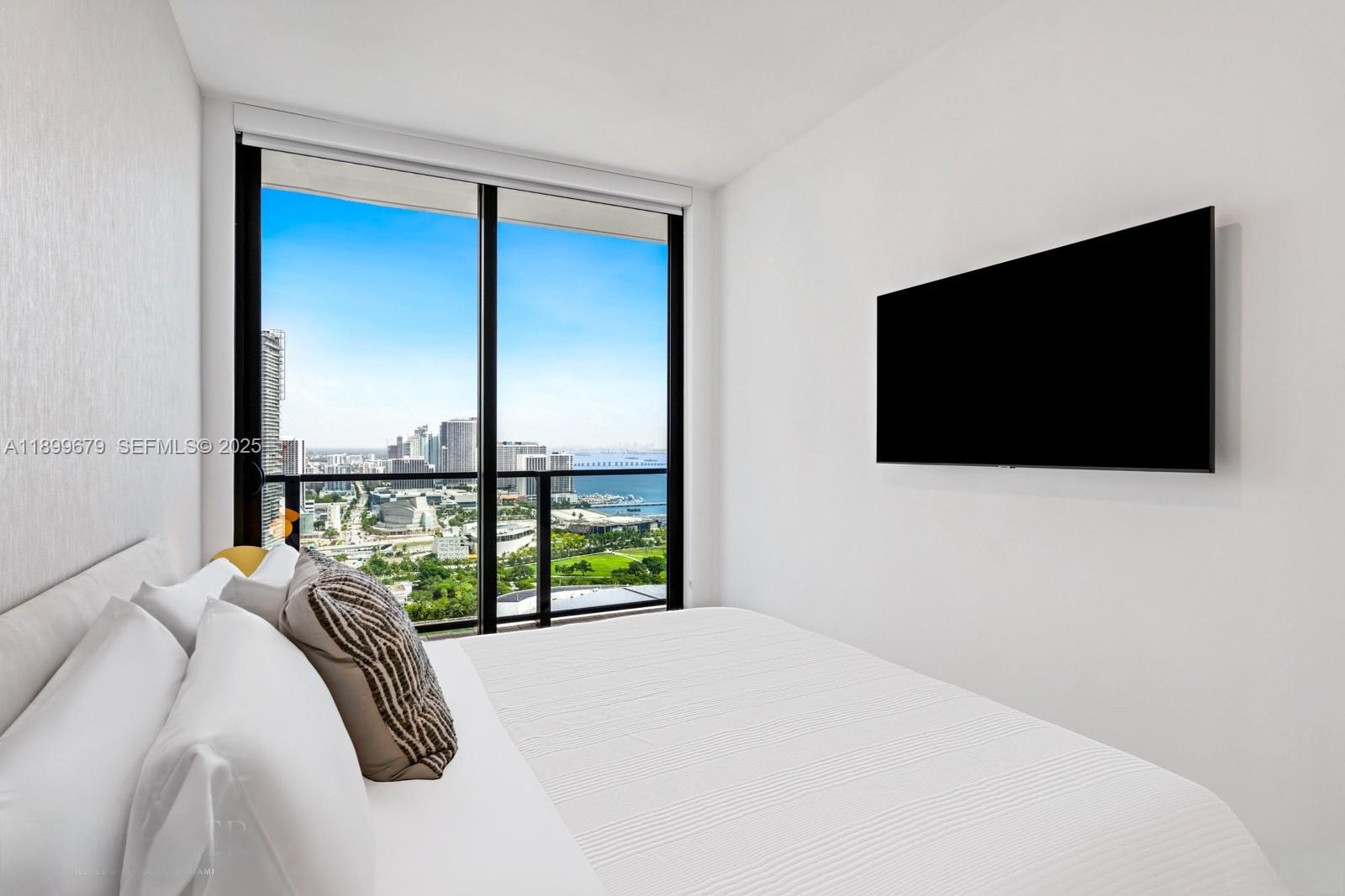 398 Northeast 5th Street, Unit 4409 Miami, FL 33132 - Photo 8 of 30 a view of a bedroom with a flat screen tv