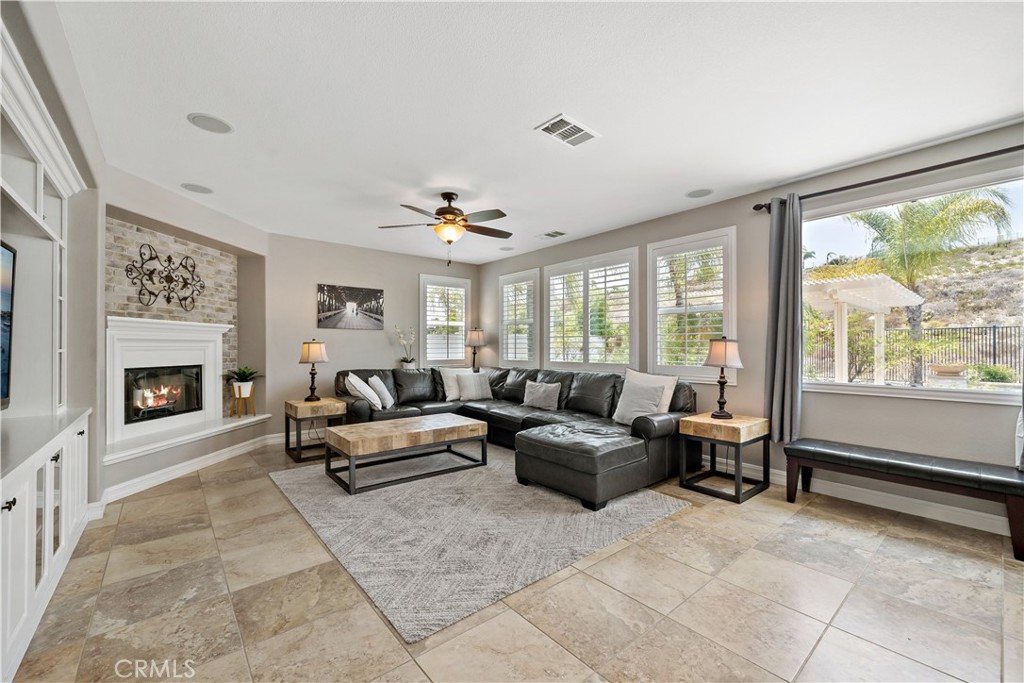 34150 Starpoint Street Temecula, CA 92592 - Photo 15 of 65 a living room with furniture and a fireplace