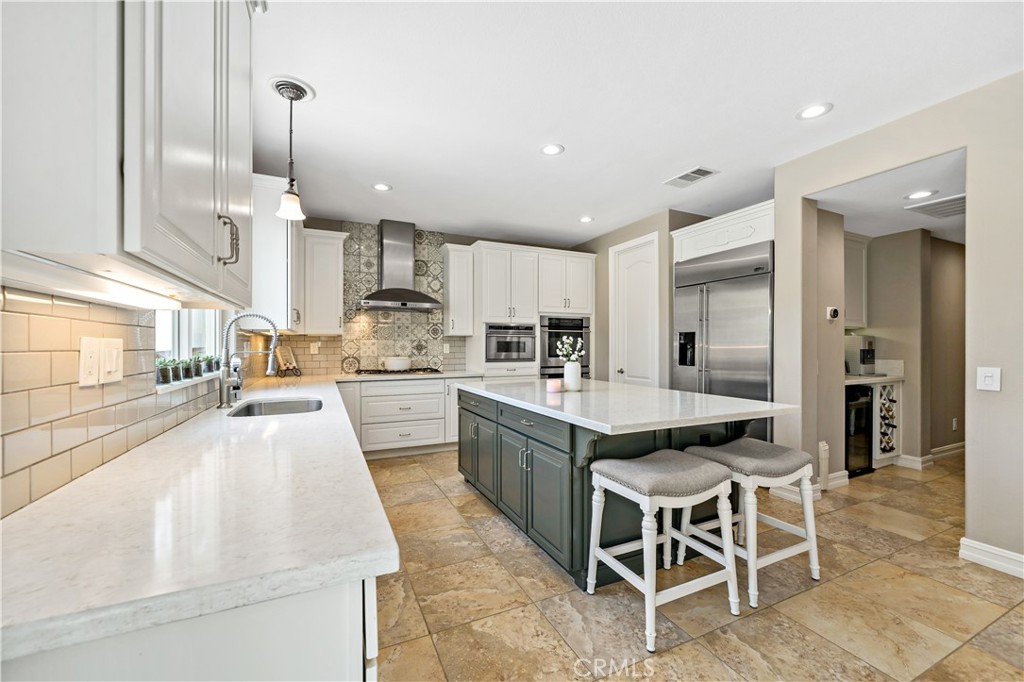 34150 Starpoint Street Temecula, CA 92592 - Photo 23 of 65 a kitchen with granite countertop stainless steel appliances a sink and counter space