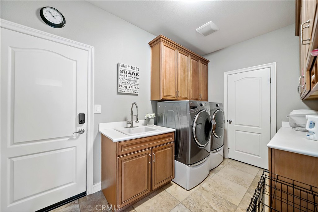 34150 Starpoint Street Temecula, CA 92592 - Photo 26 of 65 a utility room with sink dryer and washer