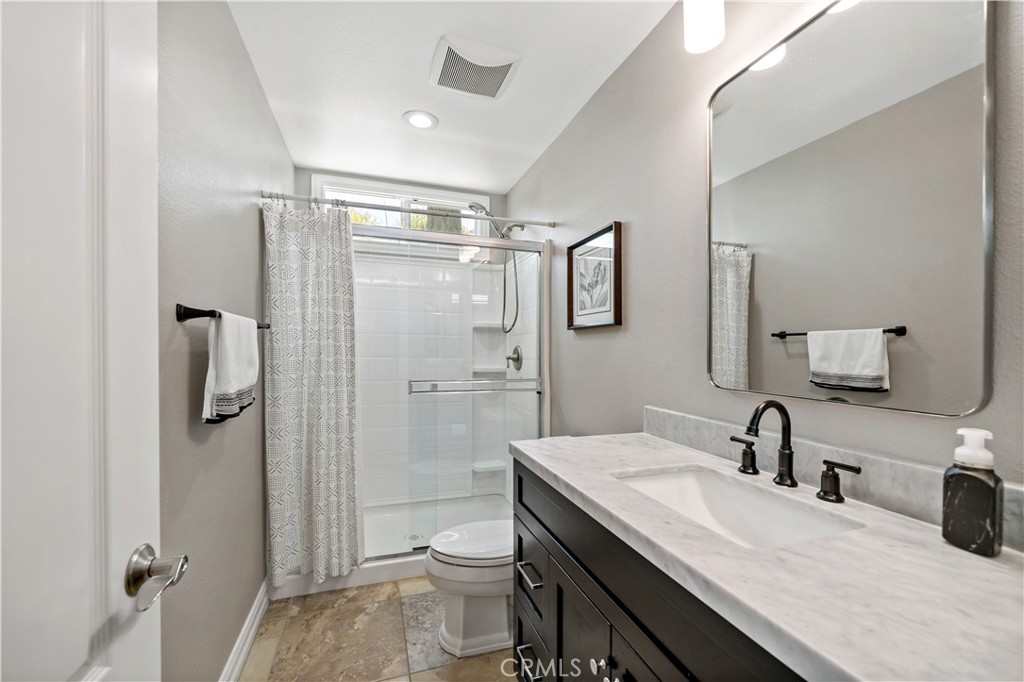 34150 Starpoint Street Temecula, CA 92592 - Photo 28 of 65 a bathroom with a double vanity sink toilet and shower