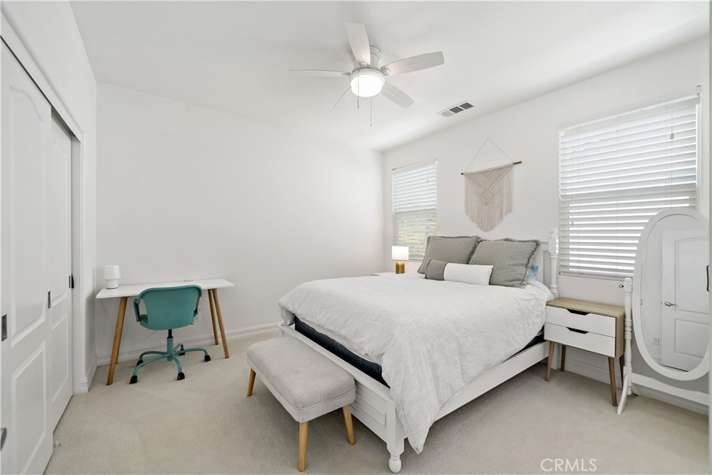 34150 Starpoint Street Temecula, CA 92592 - Photo 40 of 65 a bedroom with a bed and a chandelier