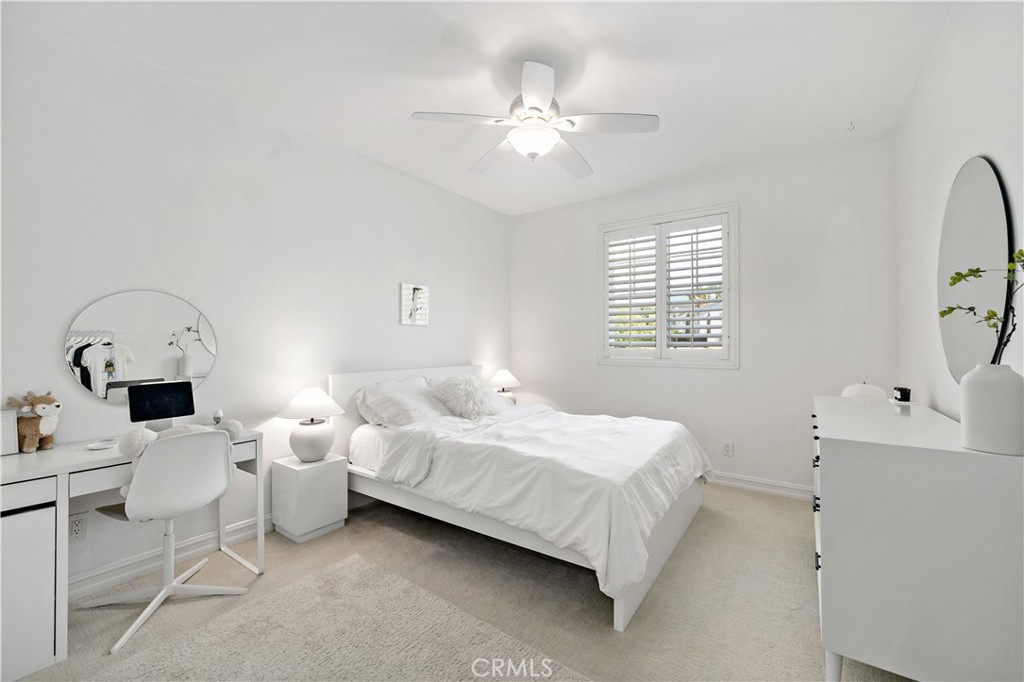 34150 Starpoint Street Temecula, CA 92592 - Photo 43 of 65 a bedroom with a bed a window and a chandelier