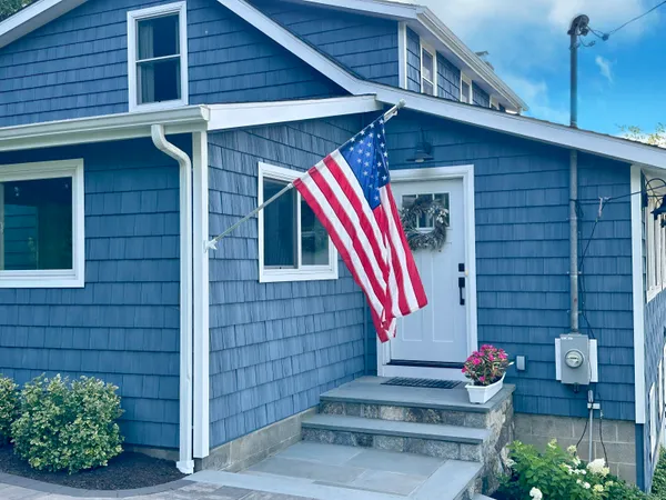 a front view of a house with fountain