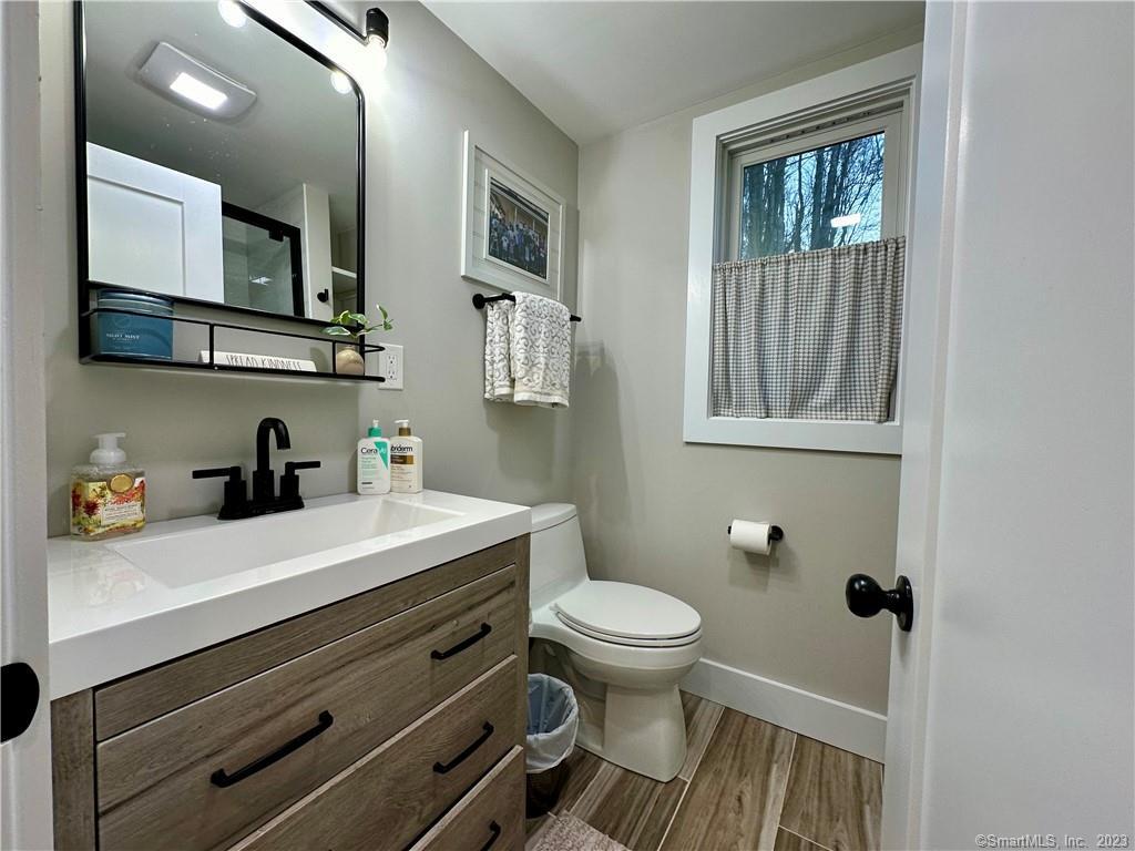 41 Candlewood Drive New Fairfield, CT 06812 - Photo 8 of 16 a bathroom with a sink a toilet and mirror