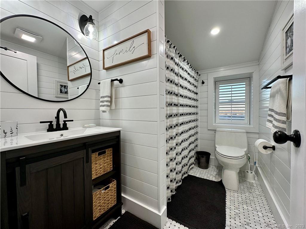 41 Candlewood Drive New Fairfield, CT 06812 - Photo 10 of 16 a bathroom with a toilet a sink and a mirror