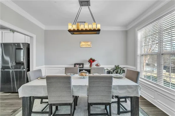 a view of a dining room that has a table and chairs in it