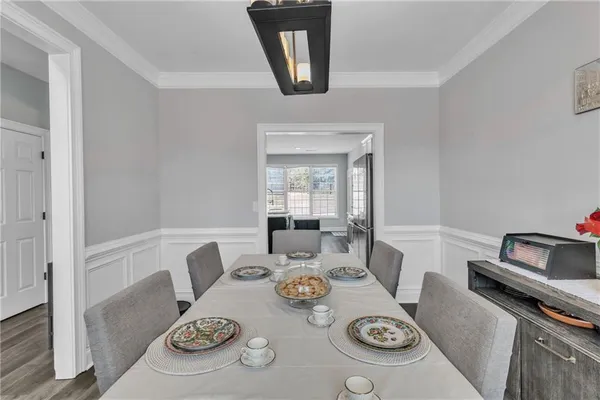 a living room with furniture a wooden floor and a chandelier