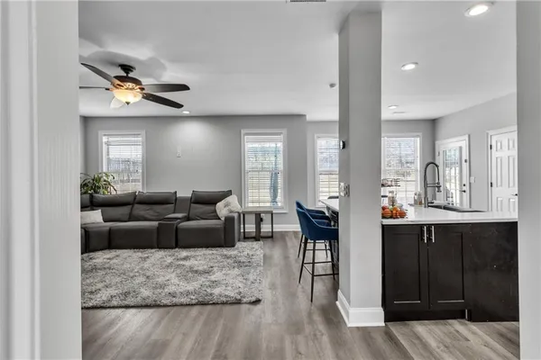 a room with a table chairs and a refrigerator