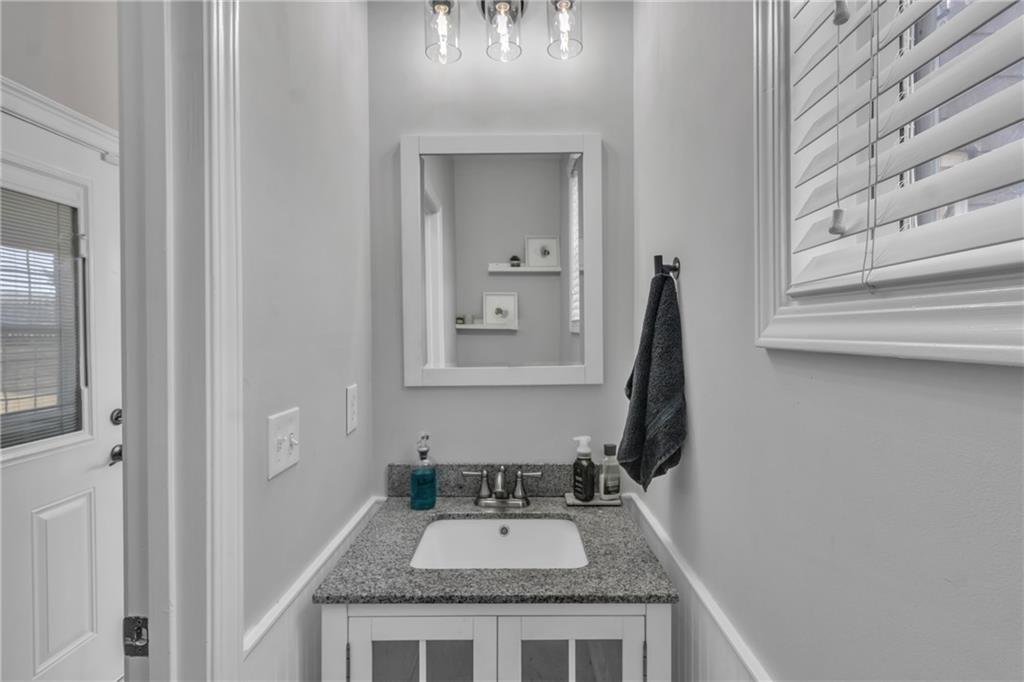 2800 Barimore Place Dacula, GA 30019 - Photo 20 of 51 a bathroom with a granite countertop sink and a mirror