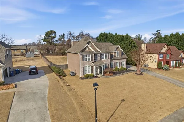 a view of a house next to a yard