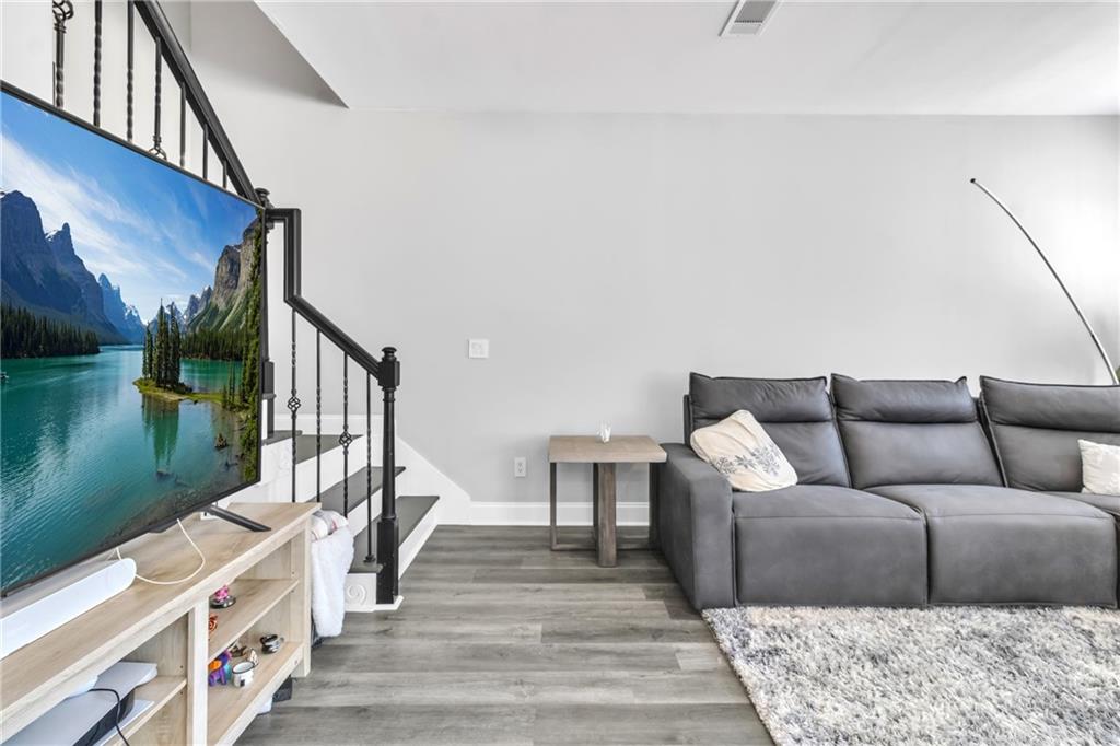 2800 Barimore Place Dacula, GA 30019 - Photo 24 of 51 a living room with furniture and a wooden floor