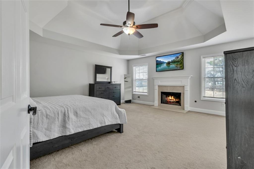 2800 Barimore Place Dacula, GA 30019 - Photo 26 of 51 a spacious bedroom with a bed and a fireplace