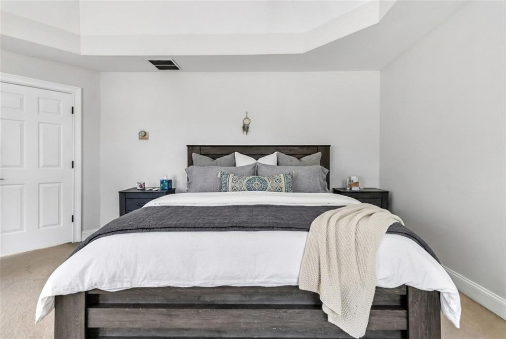 2800 Barimore Place Dacula, GA 30019 - Photo 27 of 51 a bedroom with a bed and wooden floor