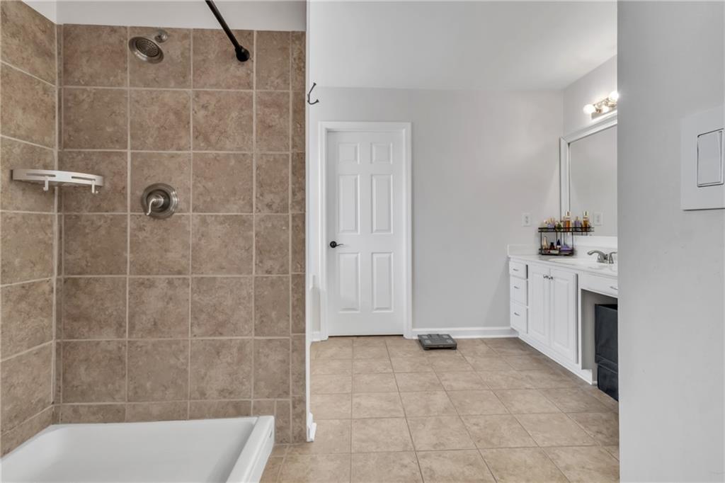 2800 Barimore Place Dacula, GA 30019 - Photo 30 of 51 a bathroom with a sink a toilet and shower
