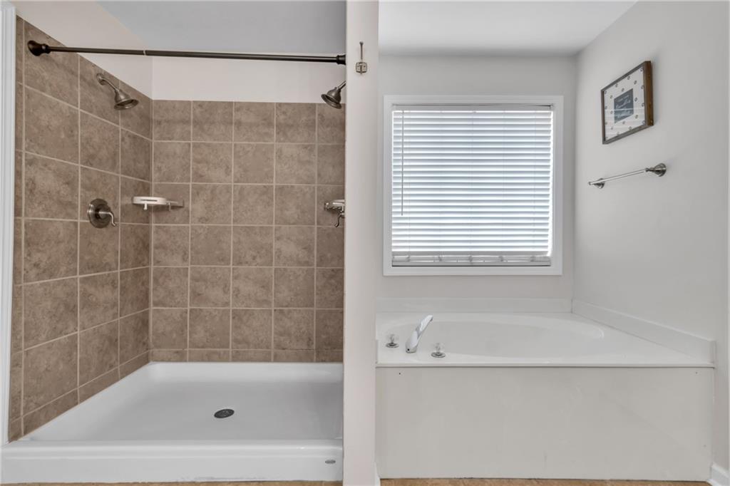 2800 Barimore Place Dacula, GA 30019 - Photo 31 of 51 a bathroom with a shower and a bathtub