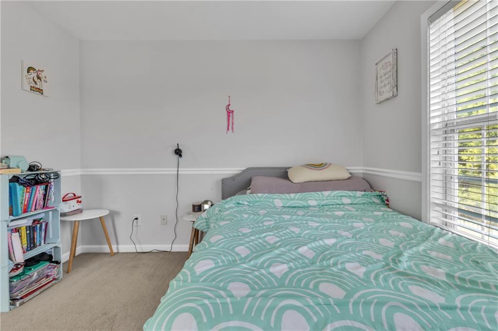 2800 Barimore Place Dacula, GA 30019 - Photo 33 of 51 a bedroom with a bed and a book shelf