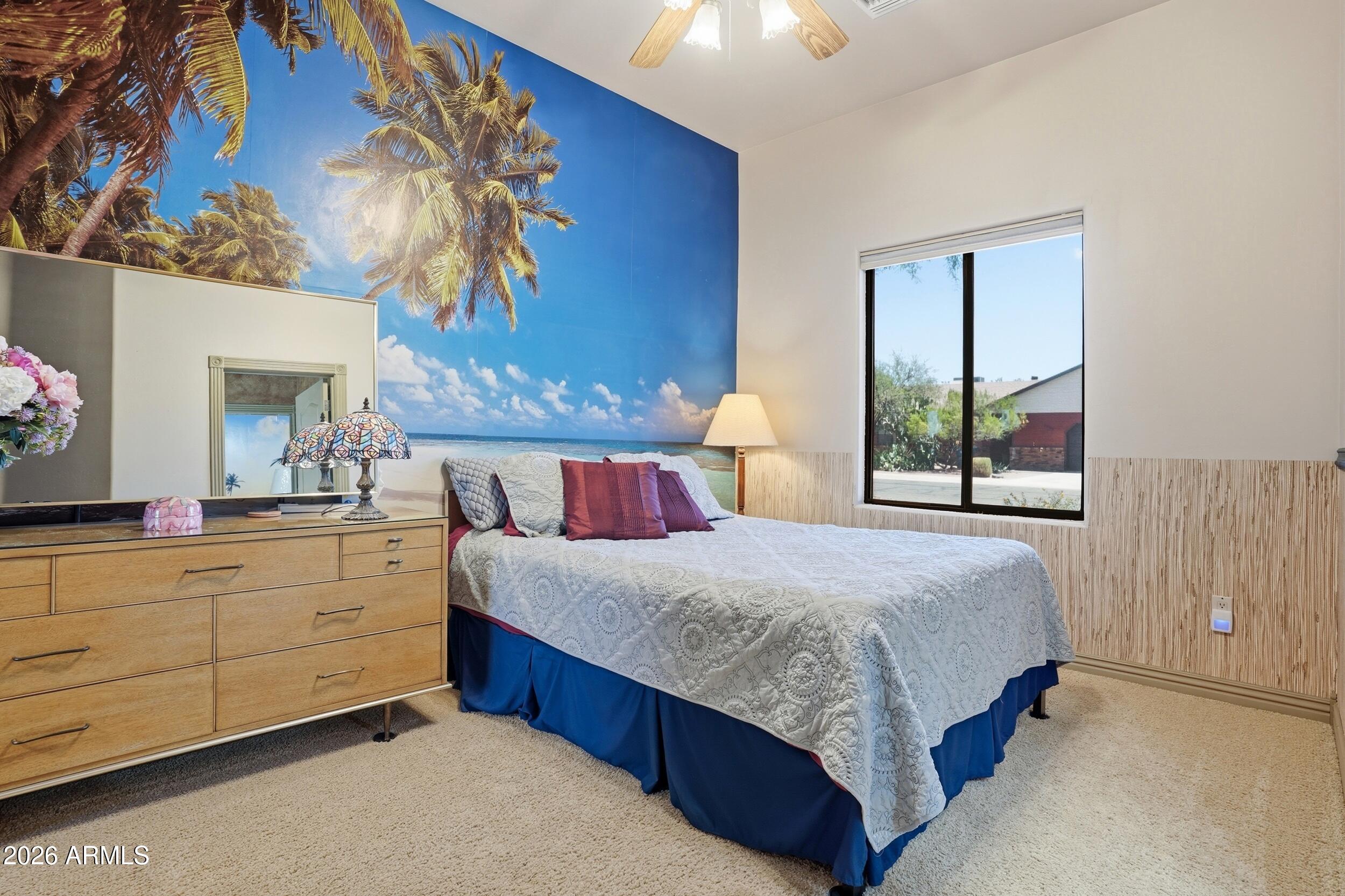 6334 East Albany Street Mesa, AZ 85205 - Photo 31 of 72 a bedroom with a large bed and a chandelier